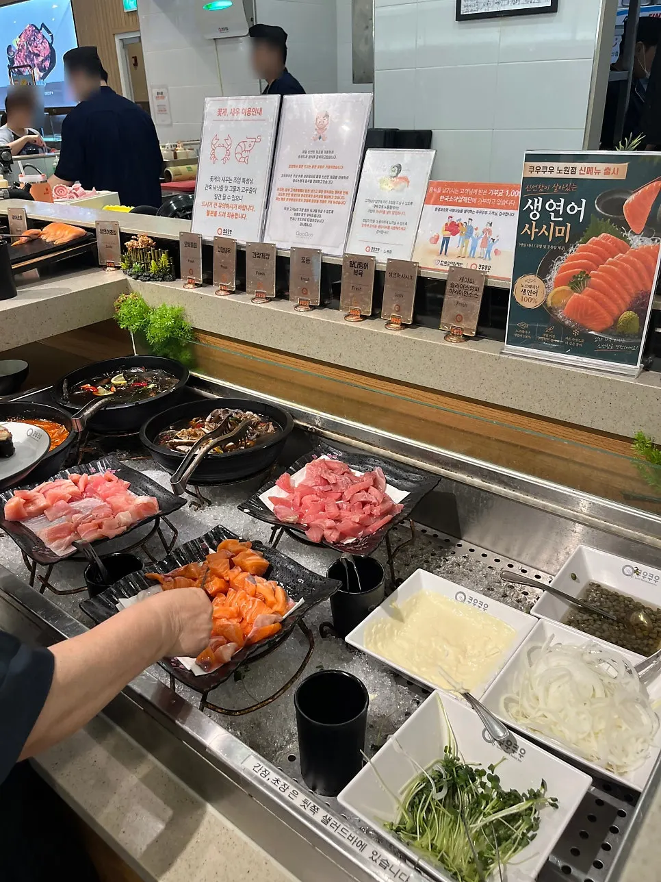 Several plates of salmon sushi brought back to the table