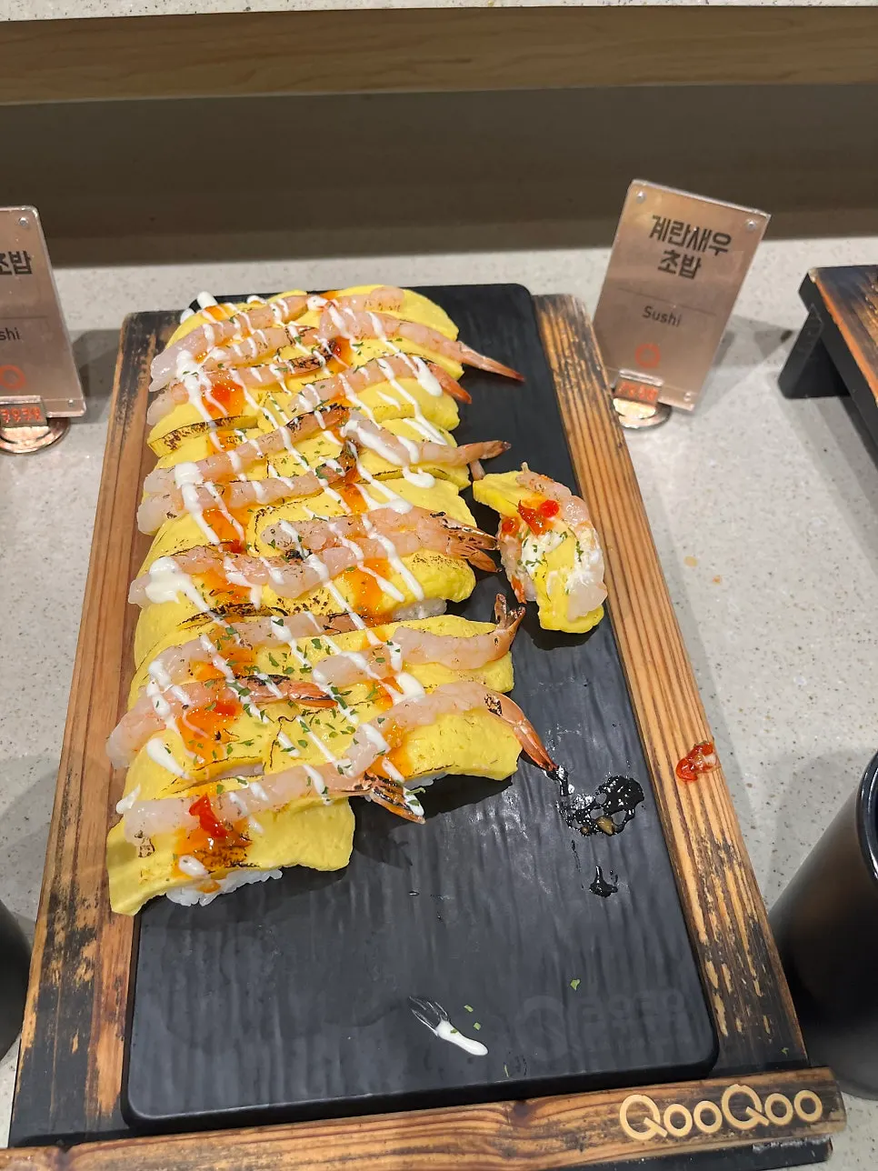 A plate loaded with various types of sushi