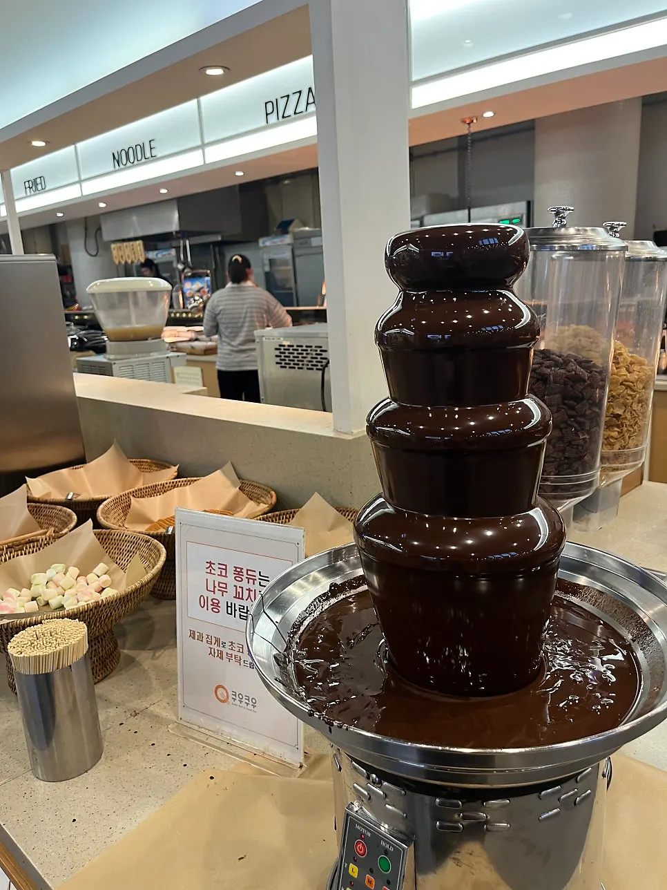 Oreo cookies dipped in a chocolate fountain