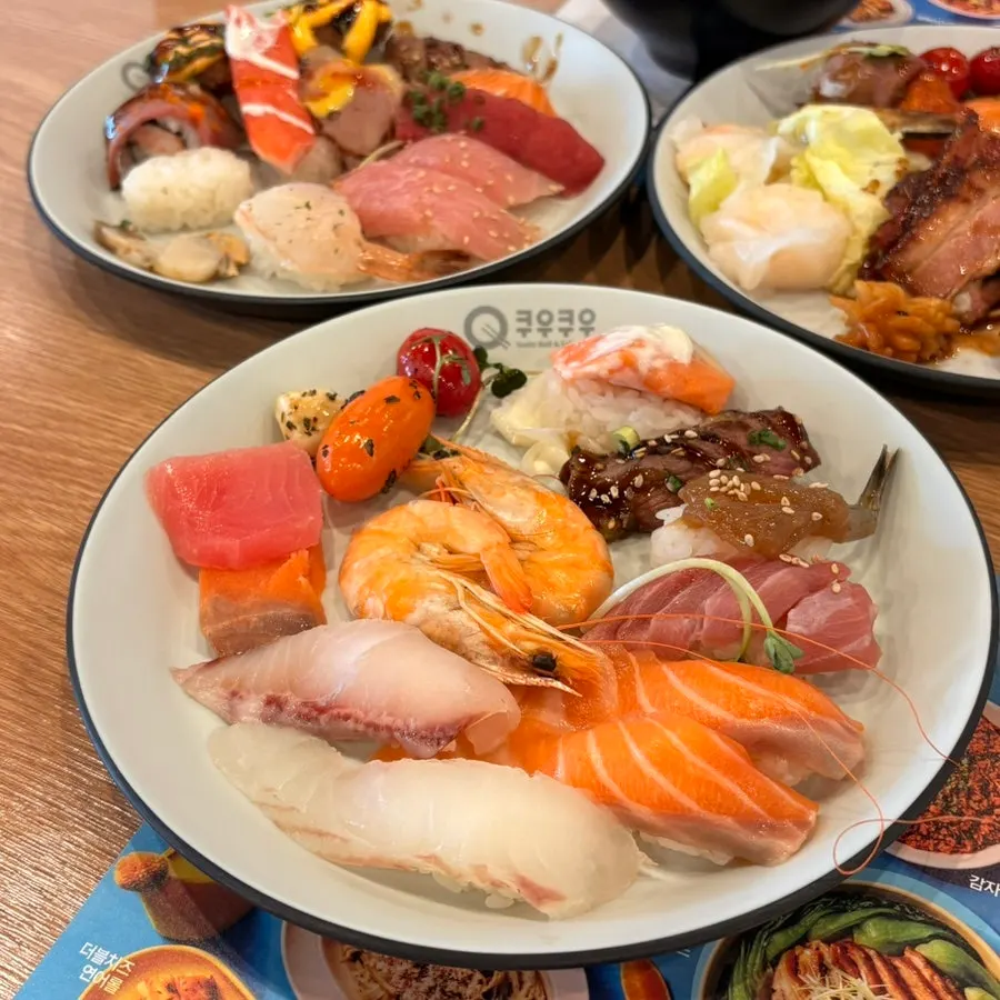First plate loaded mainly with sushi and seafood