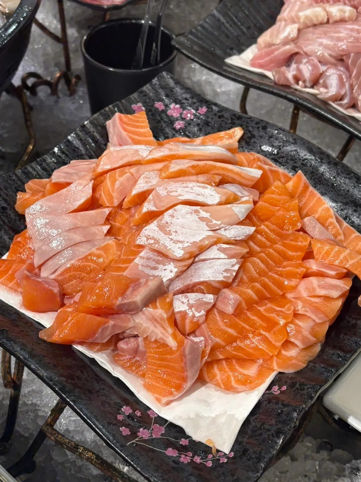 A plate of sushi and raw salmon sashimi