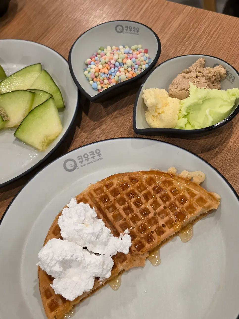 A dessert plate with waffles and crepes
