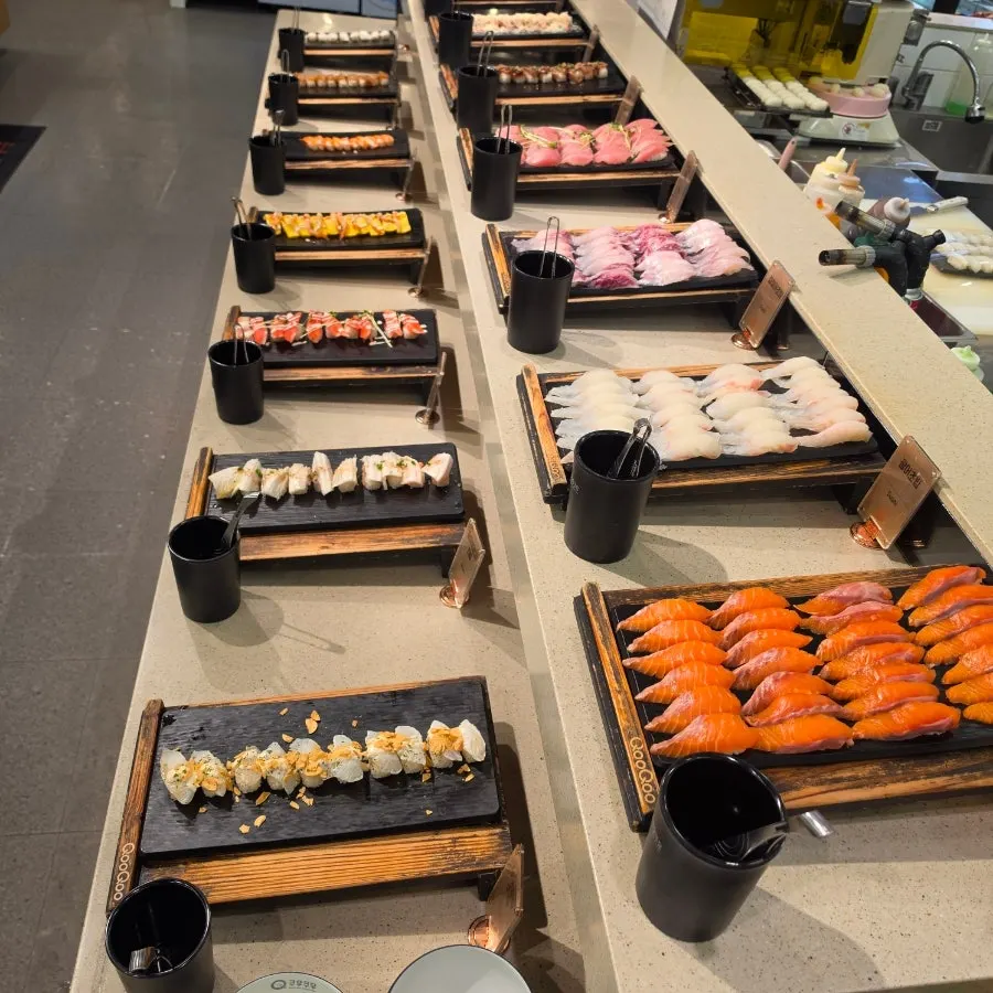 Draft beer poured in glasses next to sushi plates