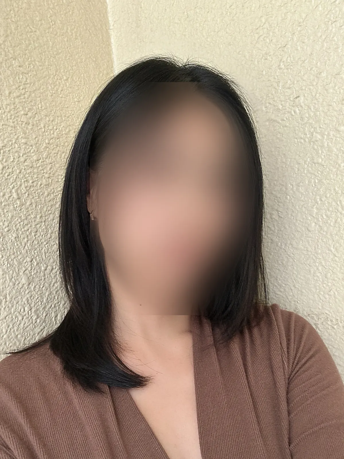 Front view of long hair tidied with a volume slick perm