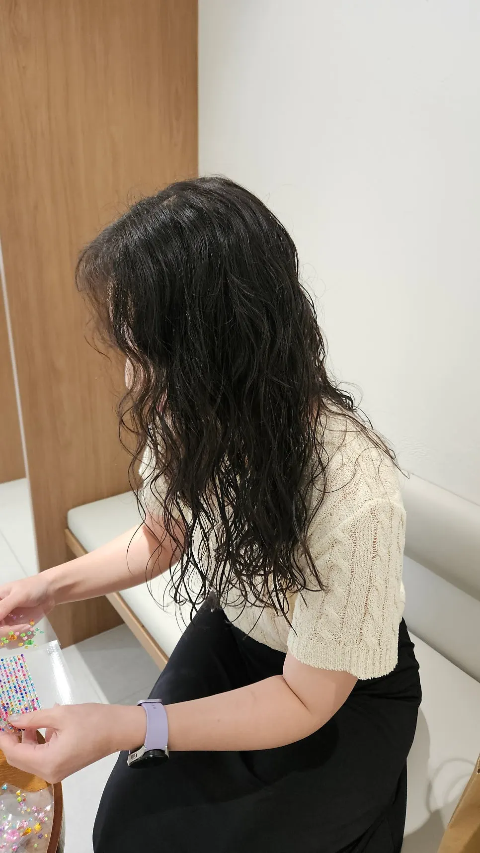 Checking the finished wave perm while seated