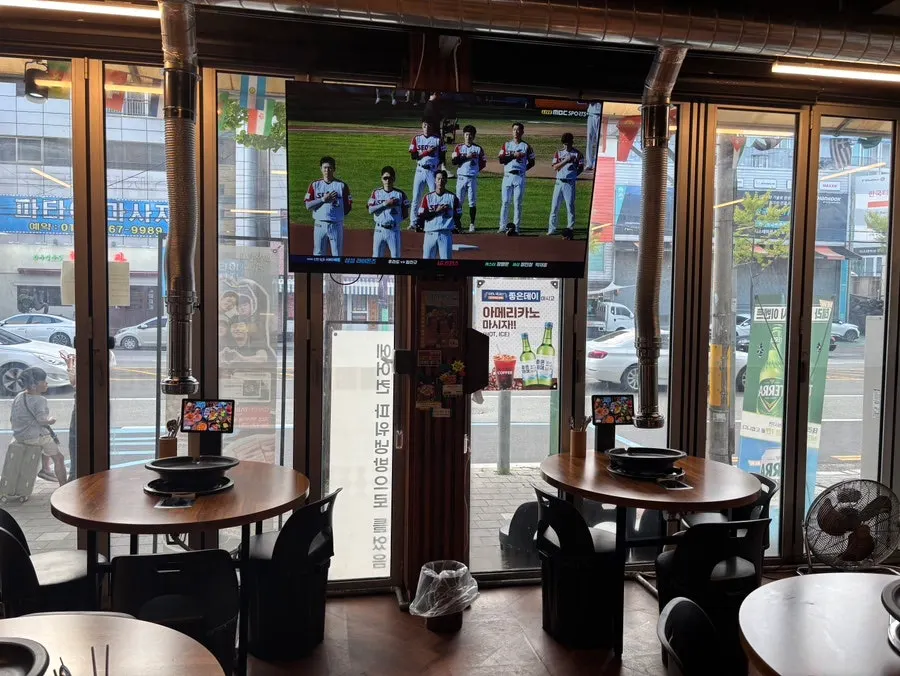 Restaurant wall hung with soccer and baseball jerseys