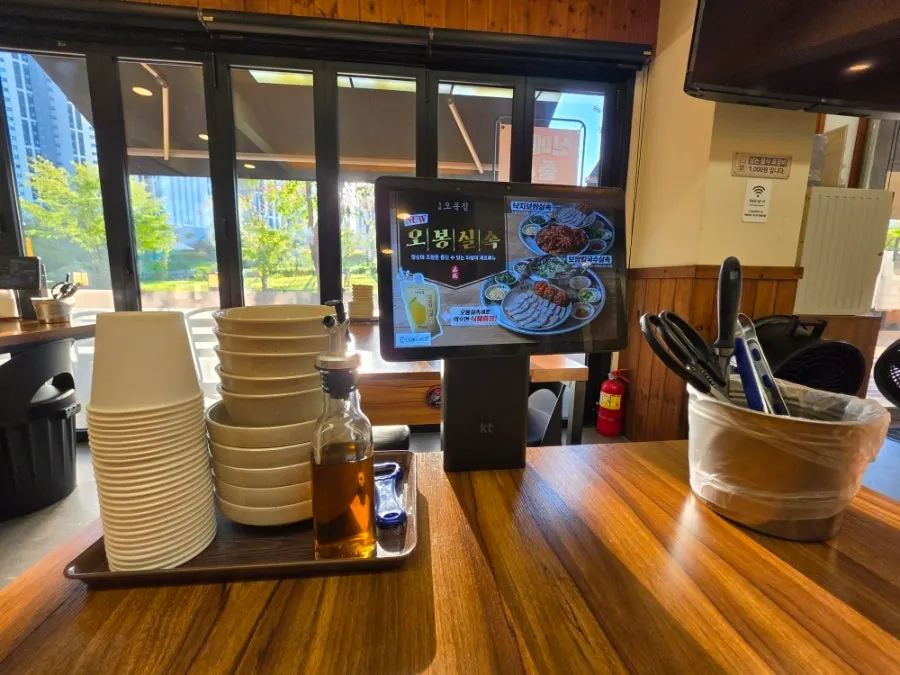 Wide dining hall with menu photos on the wall