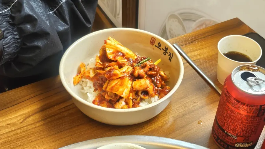 A chopstick-lifted bite of the octopus stir-fry