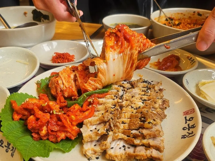 A table spread with bossam and octopus stir-fry together