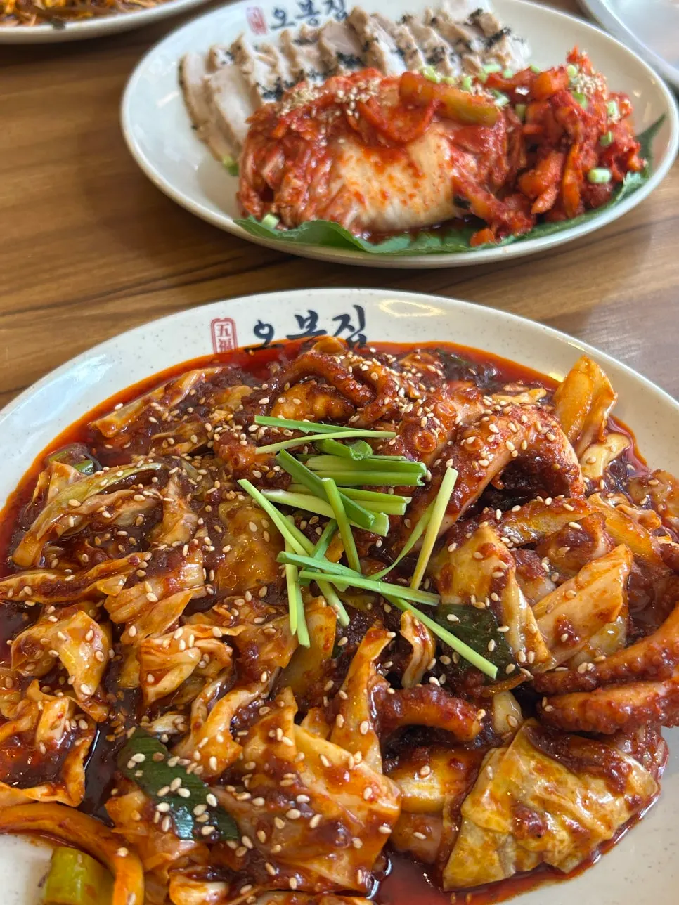 A bossam wrap topped with bossam kimchi and dried radish strips