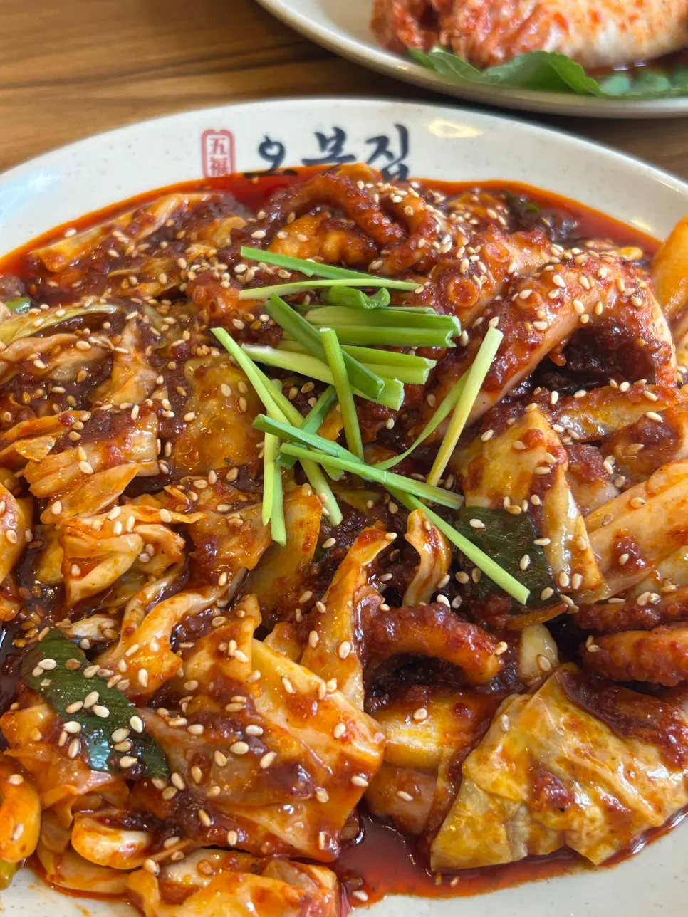 A plate of pork belly bossam served with bossam kimchi