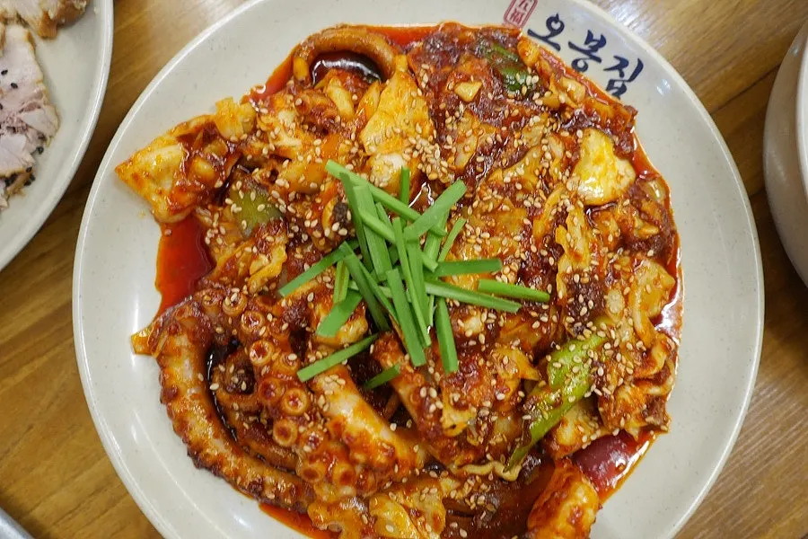 Whole octopus piled onto the fire-grilled stir-fry