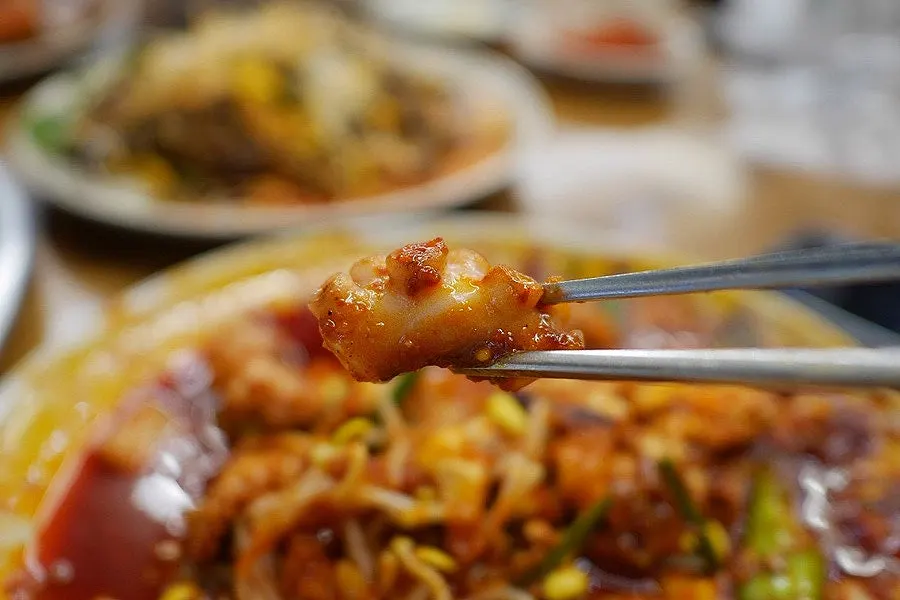 Chewy octopus stir-fry cut with scissors