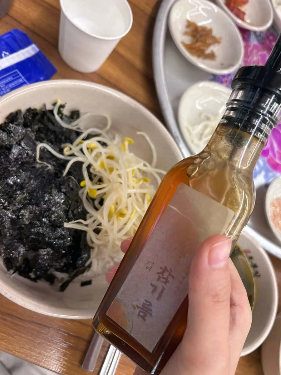 Rice topped with seaweed flakes, bean sprouts, and the squid-pork stir-fry