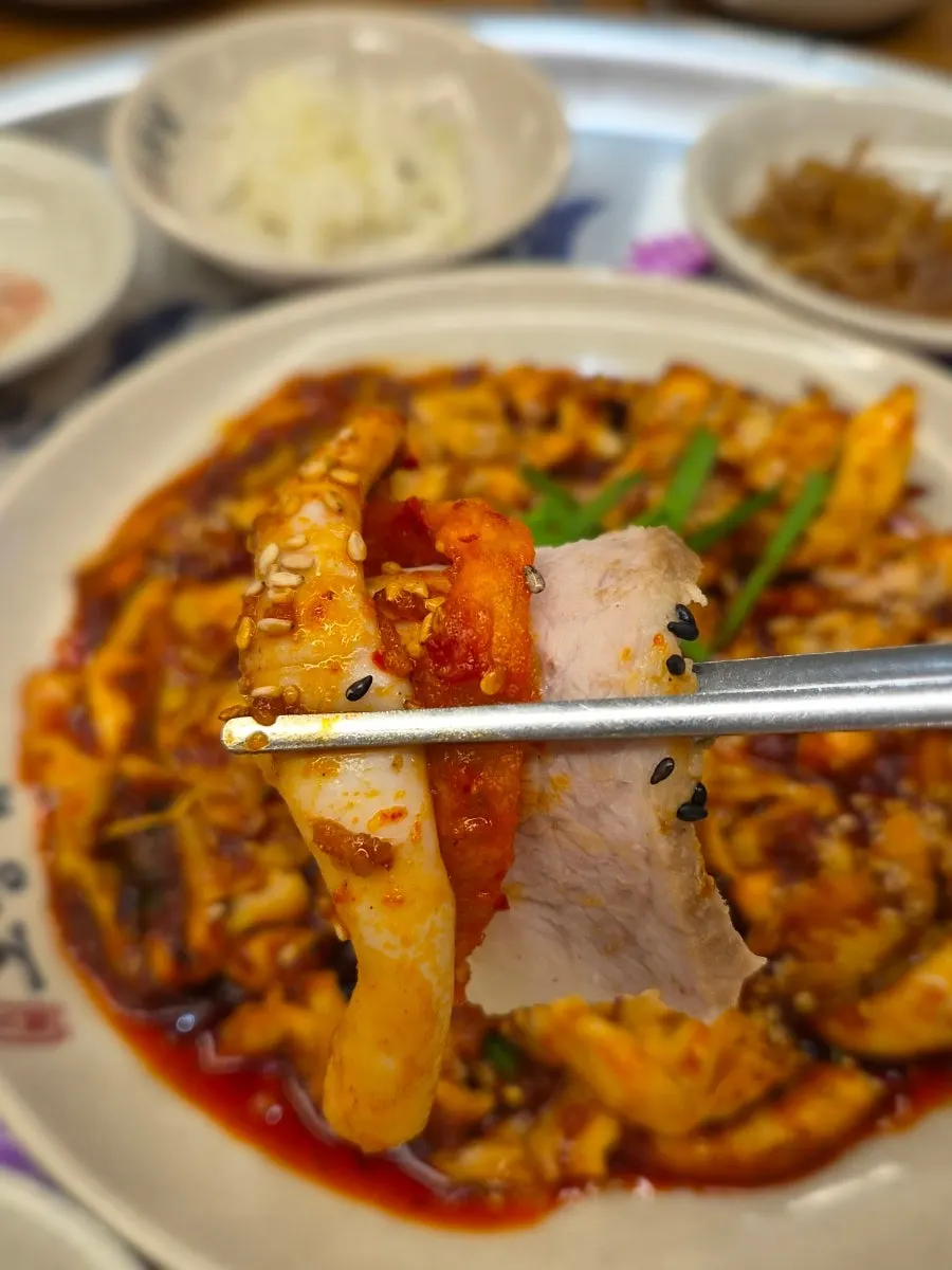 Squid stir-fry, bossam, and makguksu served together