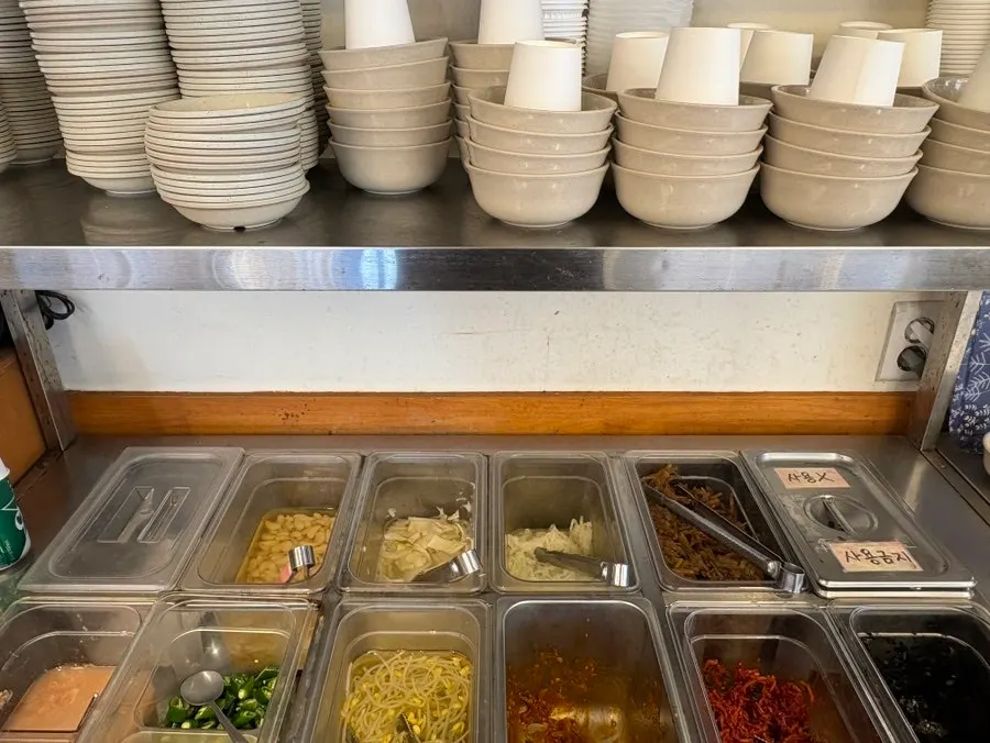 Self-serve bar with soup, rice, and side dishes