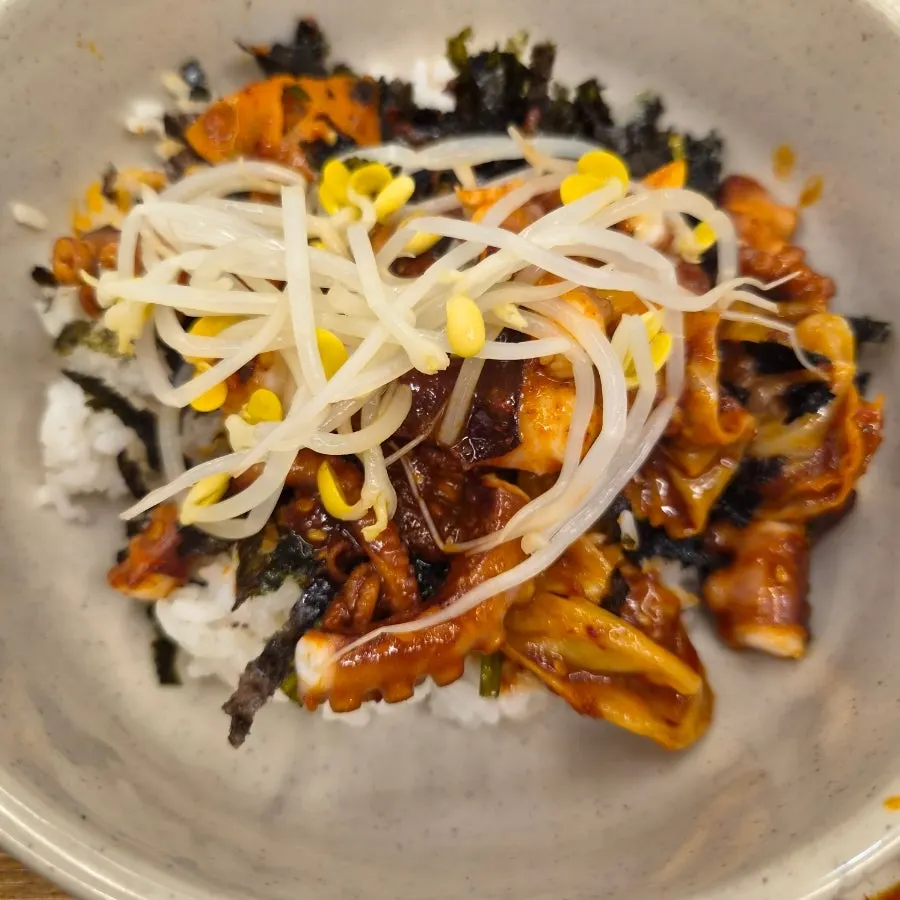 Bibimbap topped with seaweed flakes and octopus