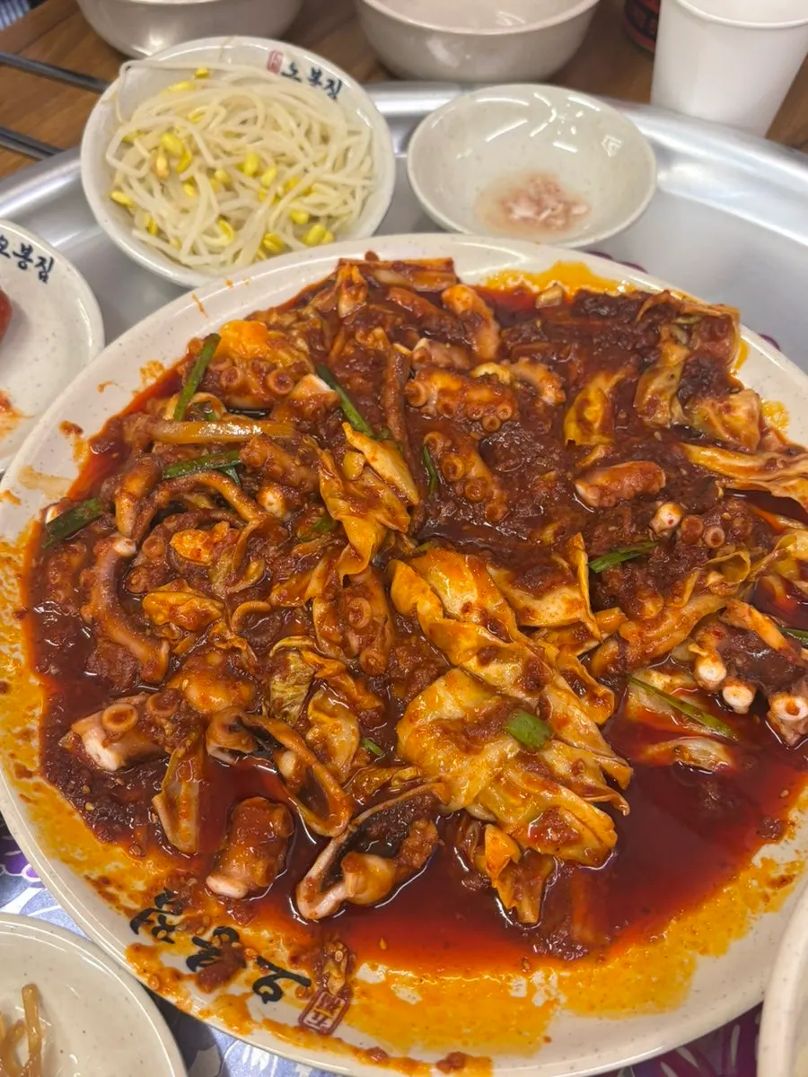 Close-up of fire-grilled octopus stir-fry with whole octopus pieces