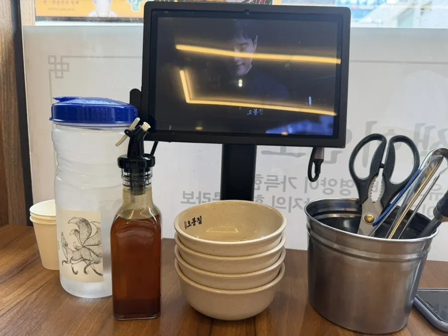 Table setting with order tablet and sesame oil bottle