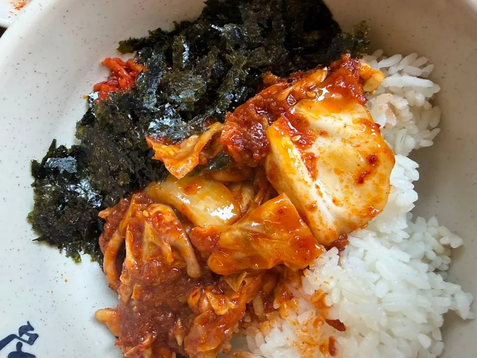 Bossam topped with kimchi and dried radish strips