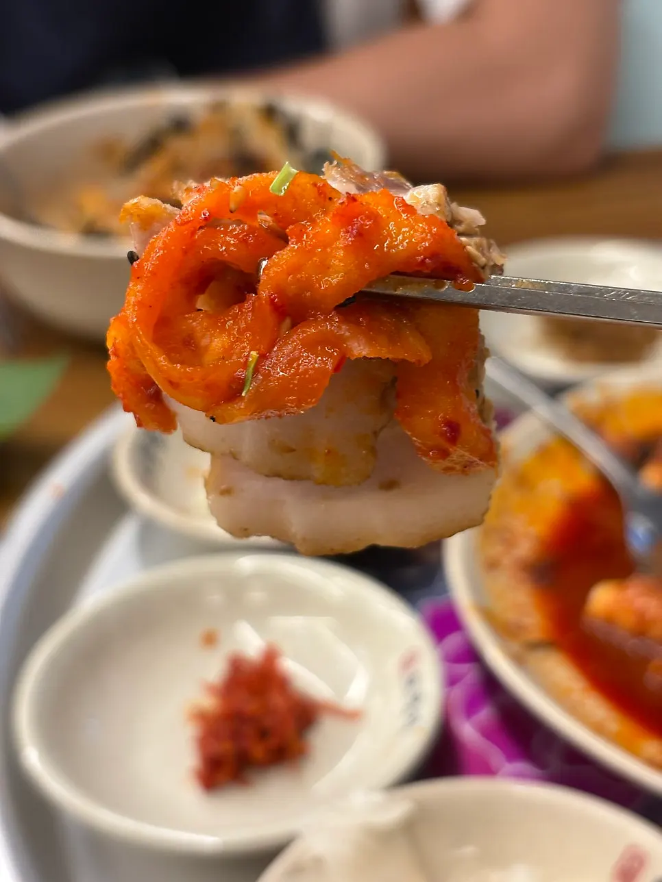 A piece of bossam topped with dried radish strips