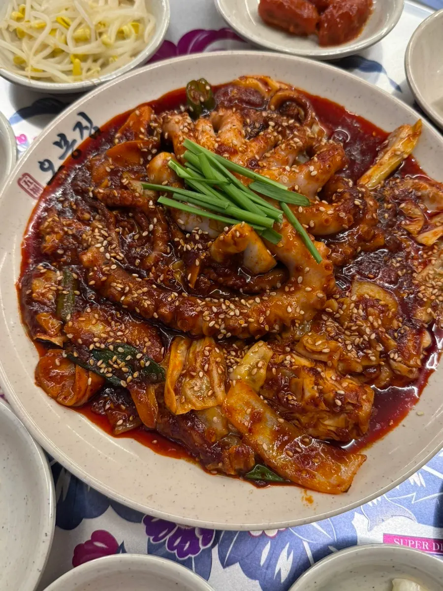 A bite of bossam topped with octopus stir-fry