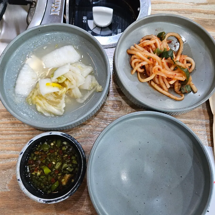 Side dishes including white kimchi and radish salad