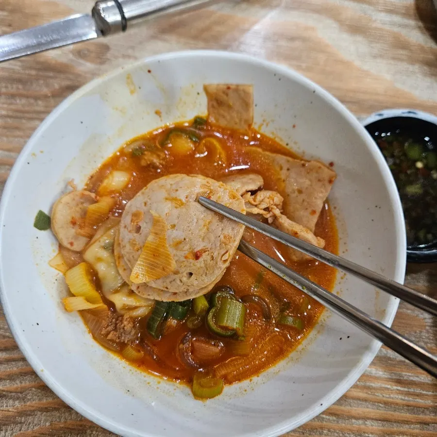 Handmade ham and vegetables scooped up with a ladle