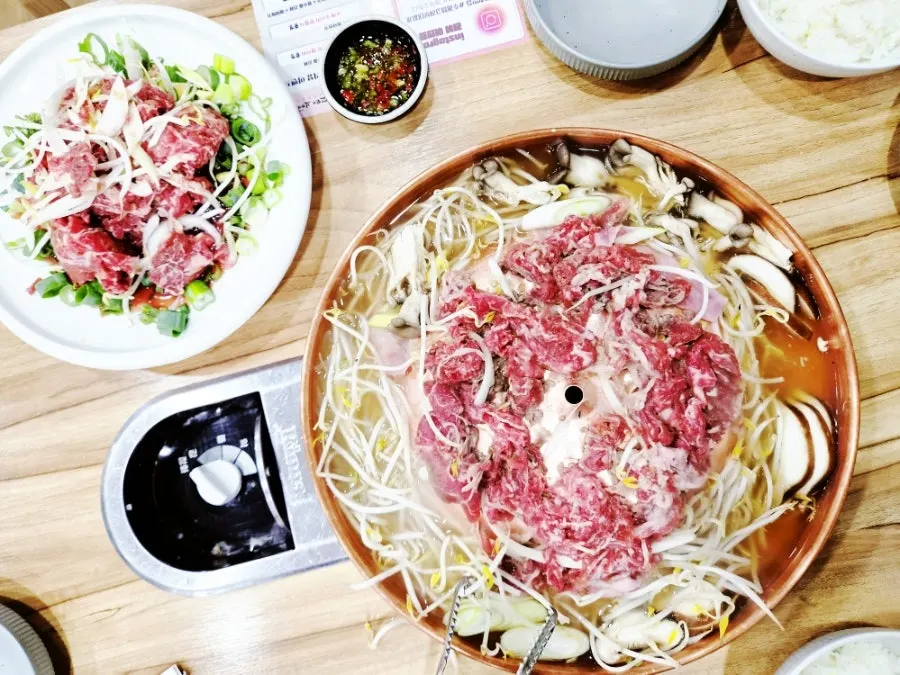 Bulgogi placed on a copper plate with a dished-in center