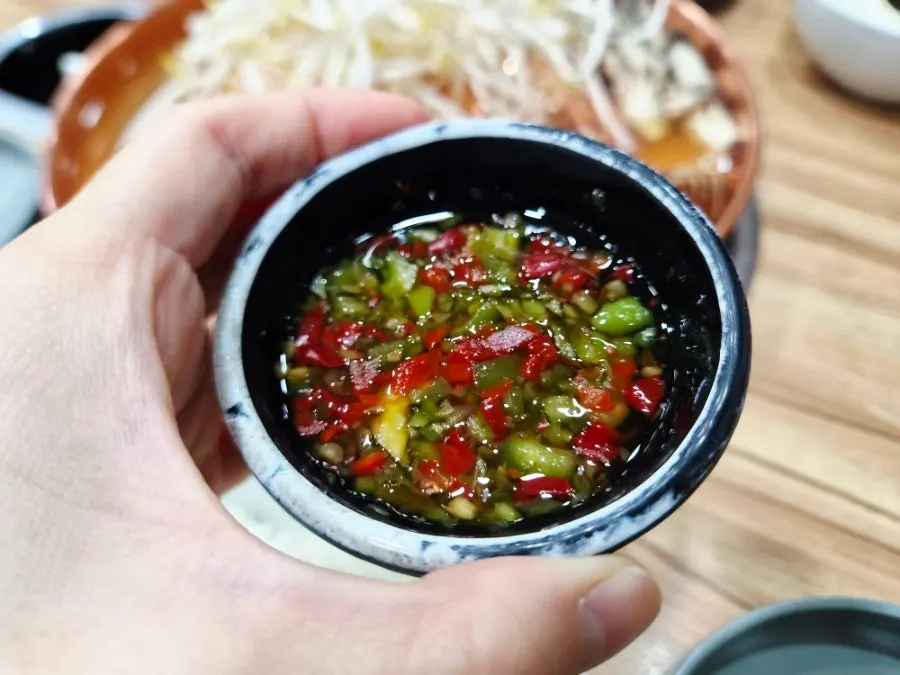 Bulgogi grilling on the copper plate with broth around the edge