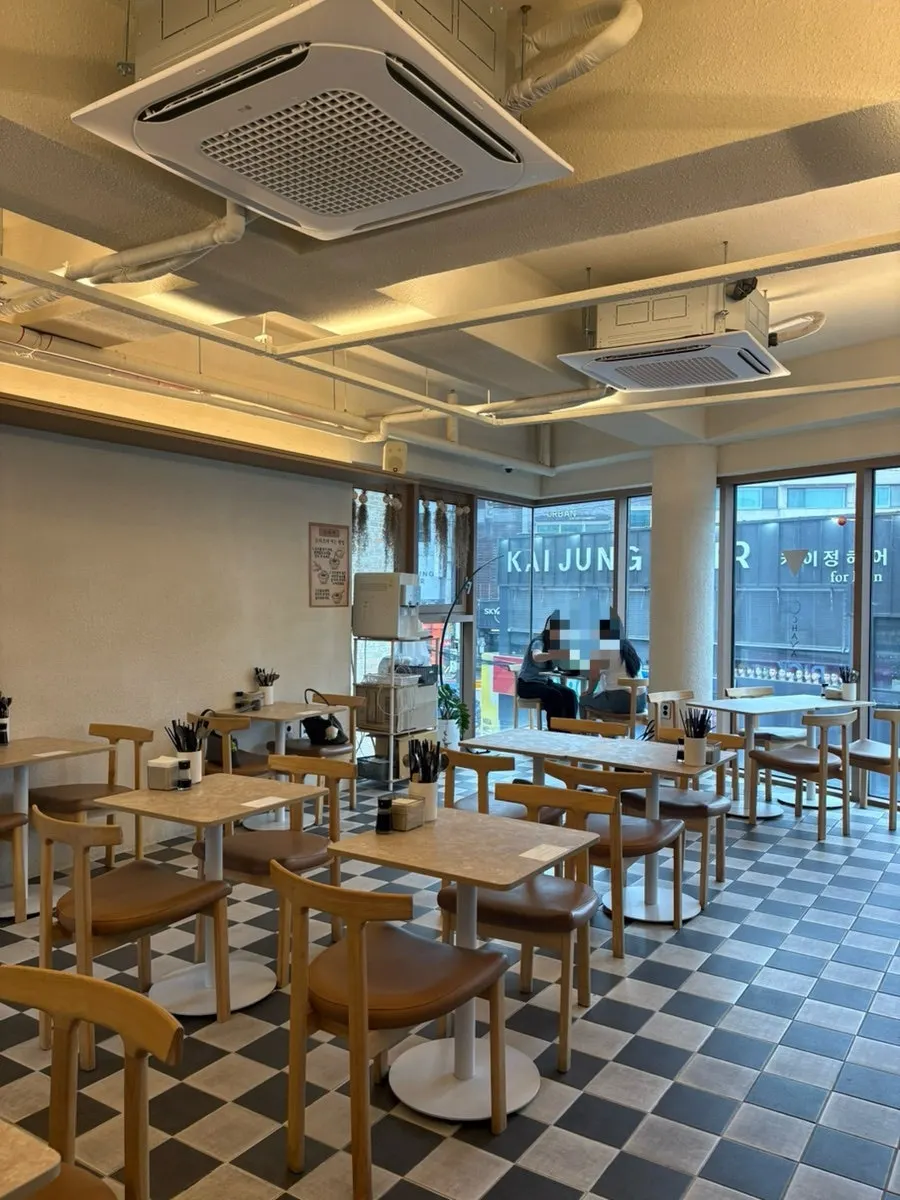 Interior of Ochaya with bar seating and tables