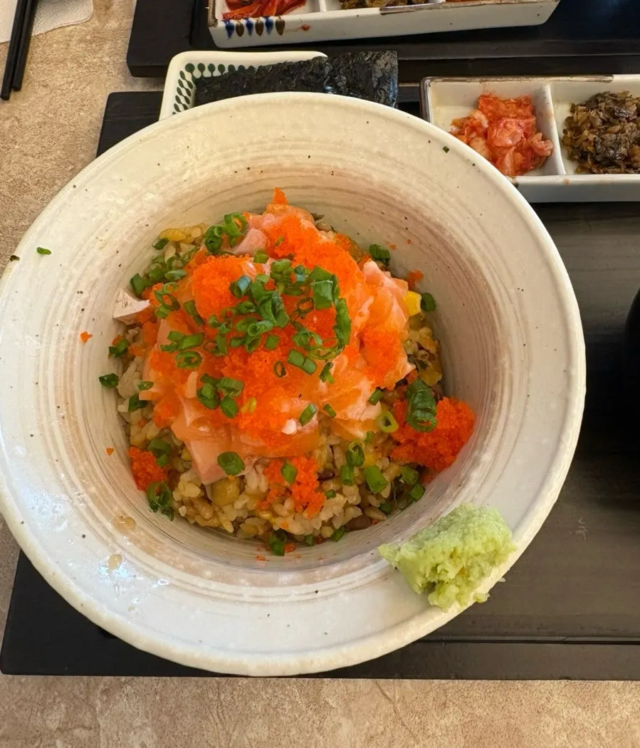 A bowl of sakechazuke topped with salmon and flying fish roe