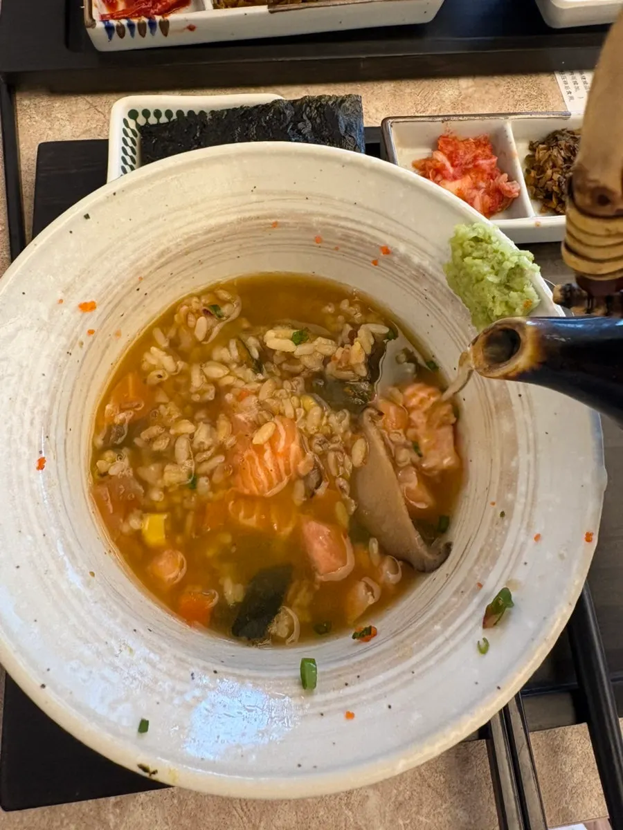 A bowl of Ochaya's ochazuke with broth poured in
