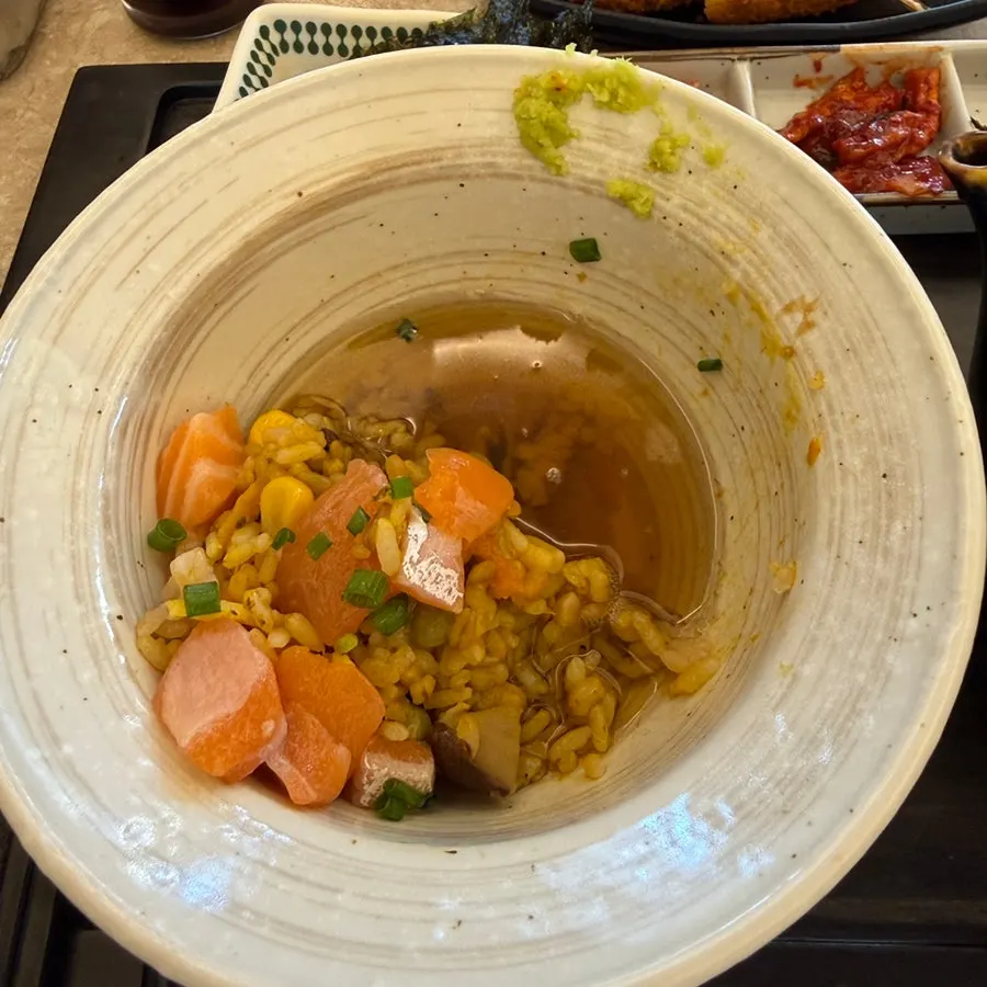 A bowl of ochazuke with broth soaking through the rice