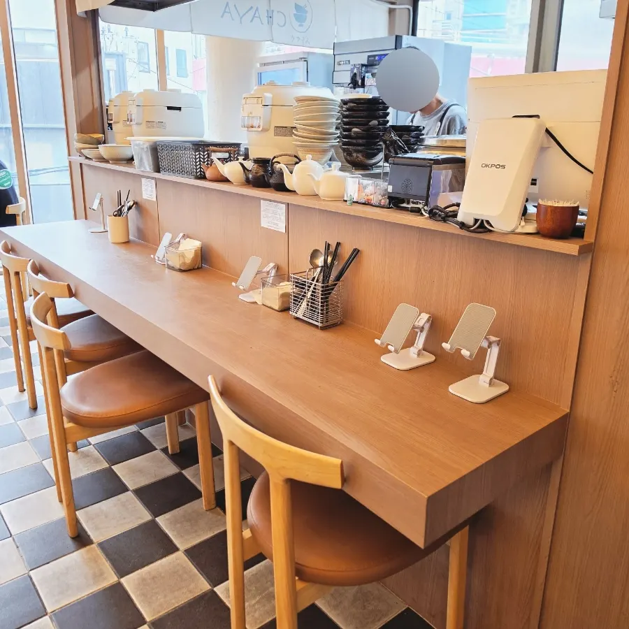 Self-serve zone at Ochaya with water, wet wipes, and aprons