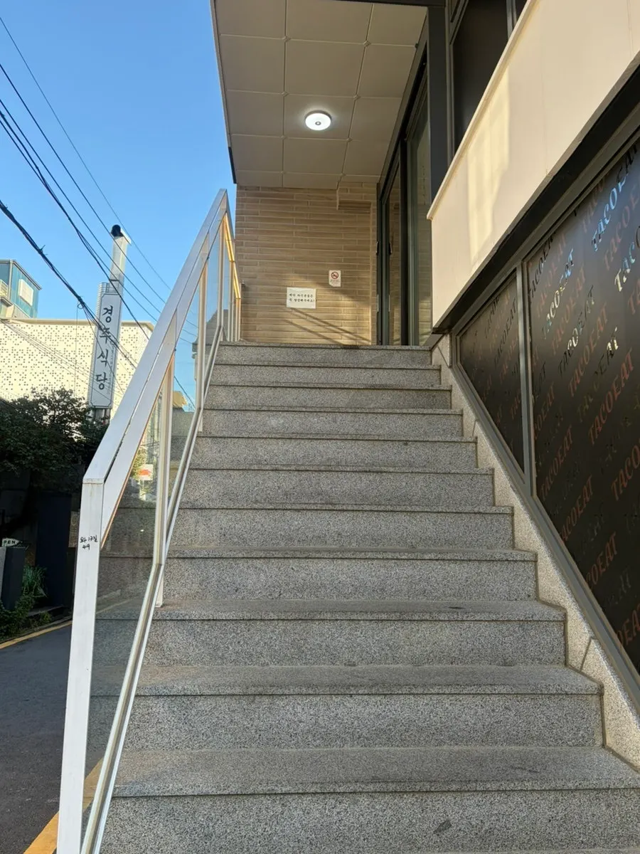 Building entrance with Ochaya's sign visible