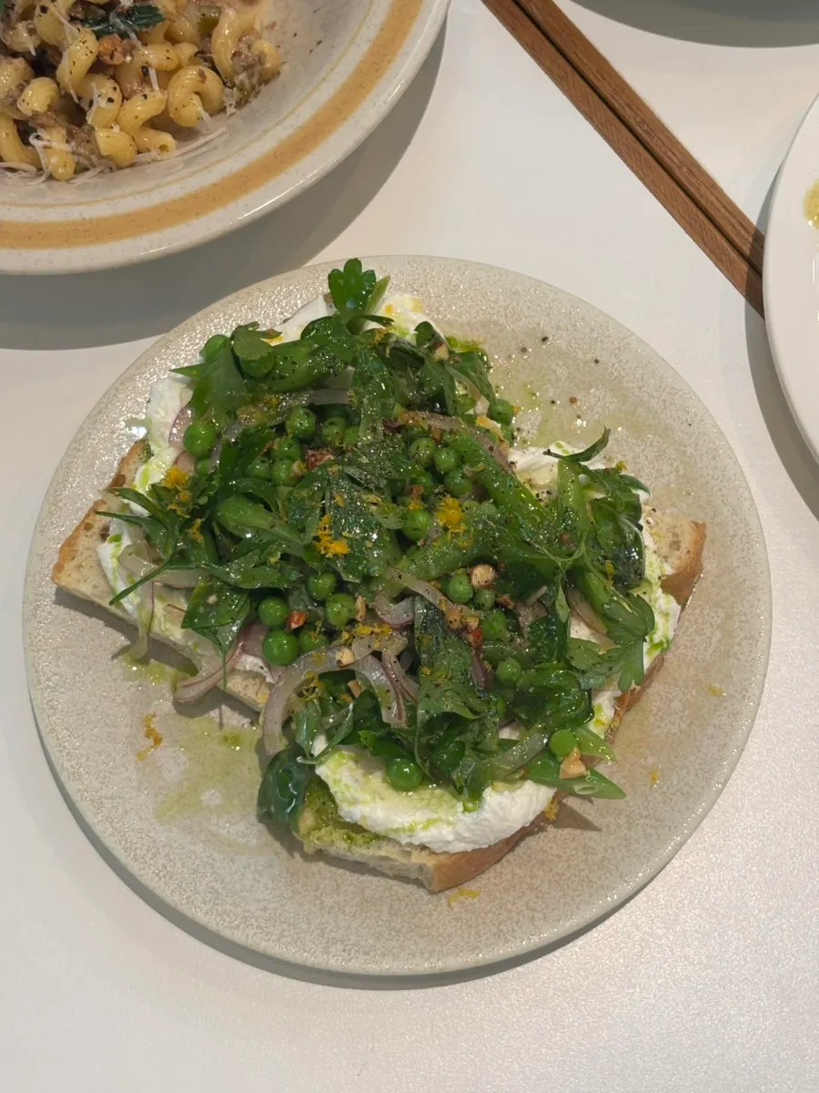 Open sandwich topped with green beans and peas