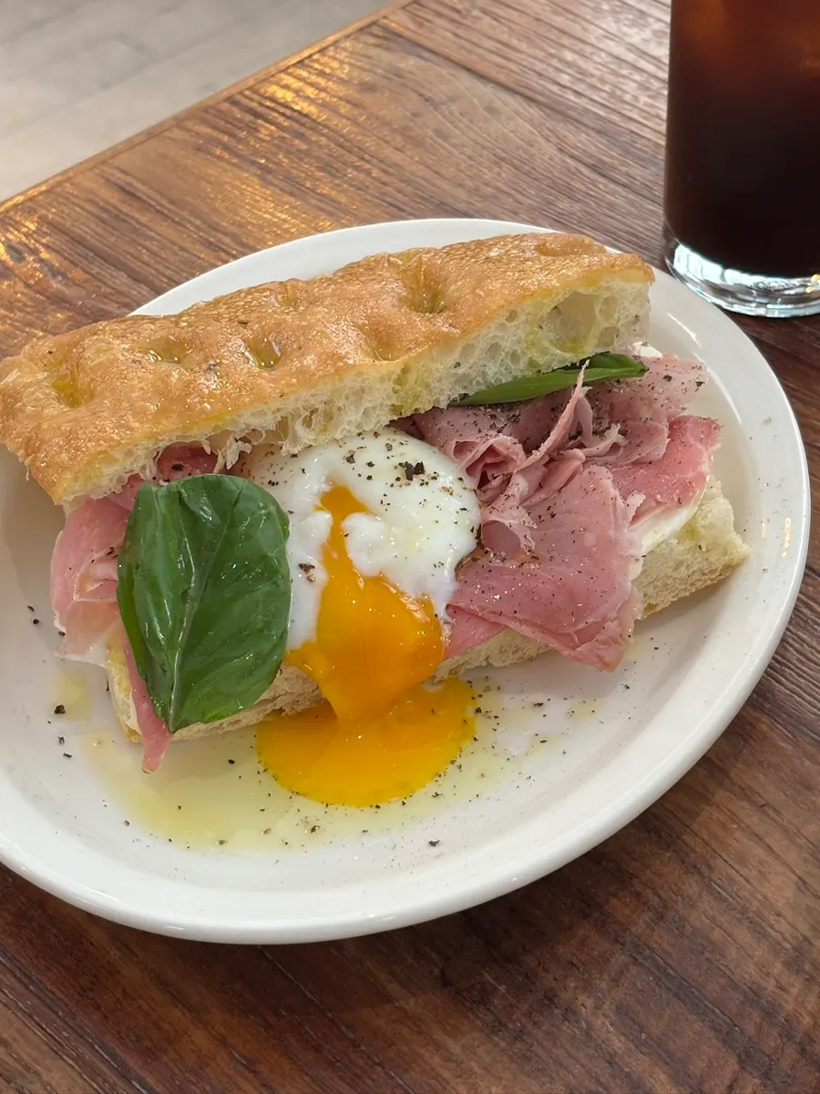 Bismarck focaccia sandwich topped with a poached egg