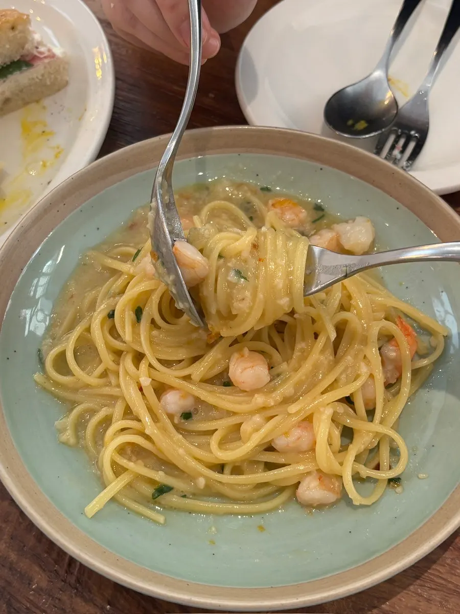 Bottarga aglio olio noodles twirled on a fork