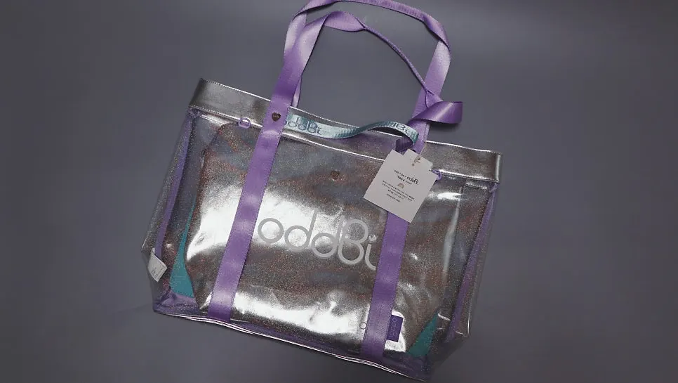 Beach bag packaged in a dust bag and plastic