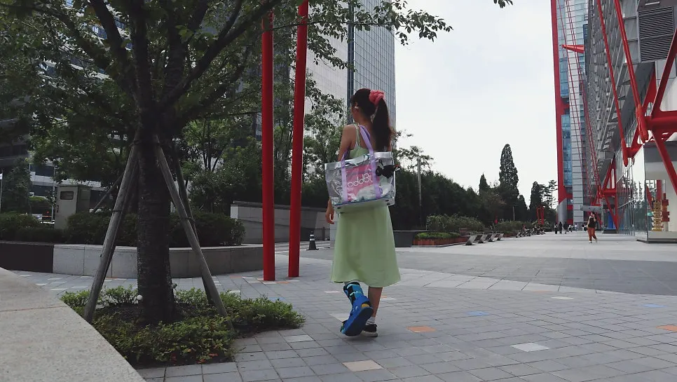Large beach bag holding a cardigan and belongings