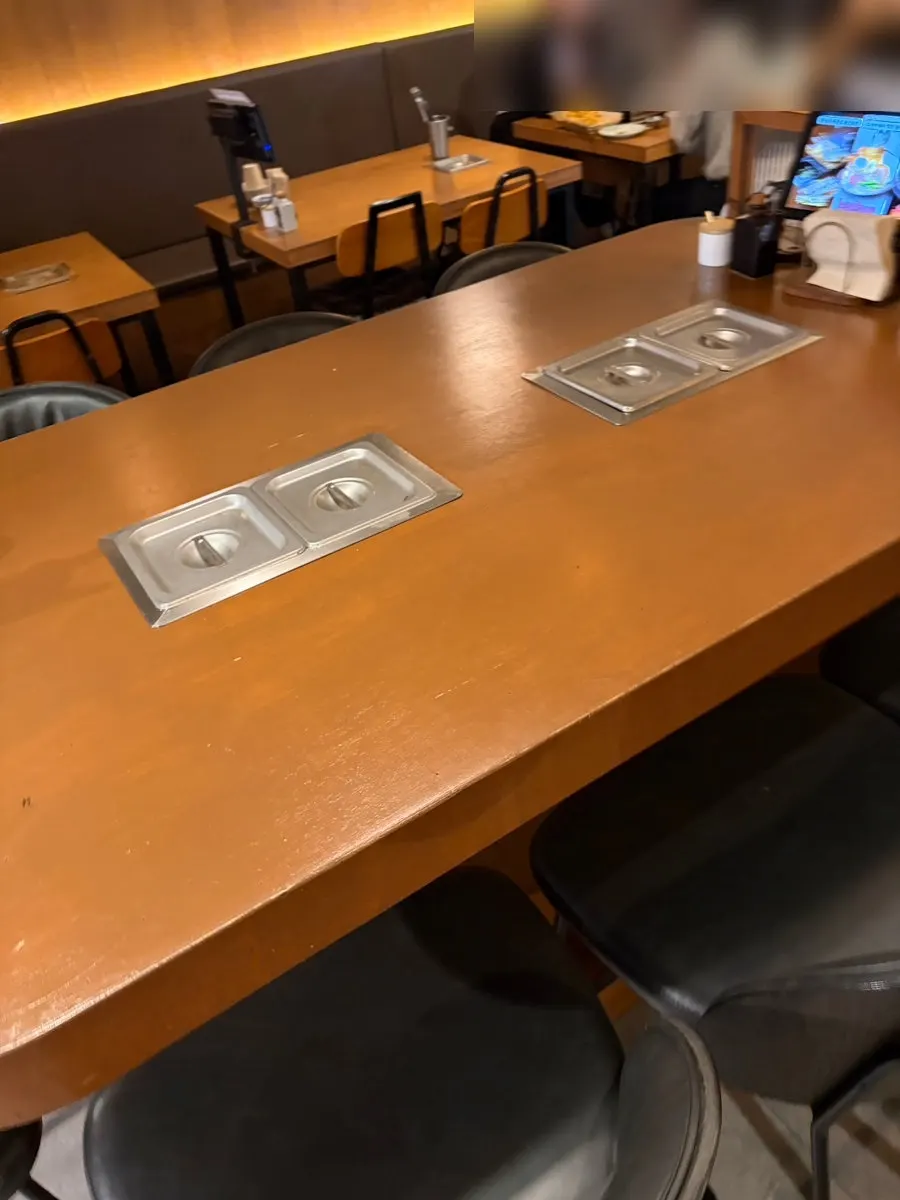 Long oden bar seating alongside regular tables