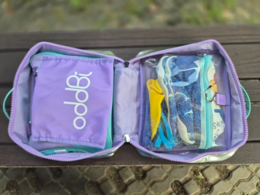 Wash bag holding swim gear and lotion
