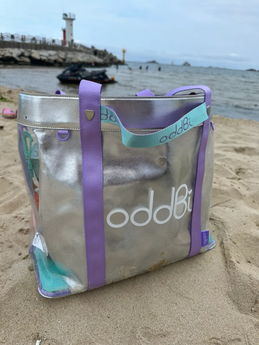 Beach bag set on sandy ground during water activities