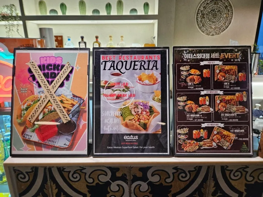 Restaurant counter displaying taco photos