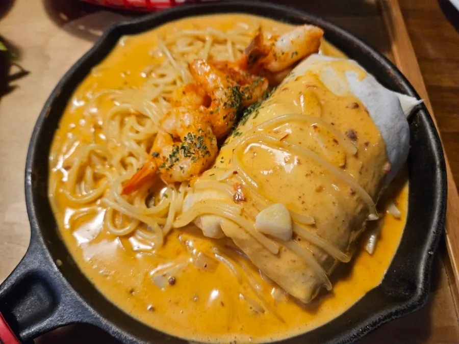 Orange chipotle cream pasta served in a cast-iron pan