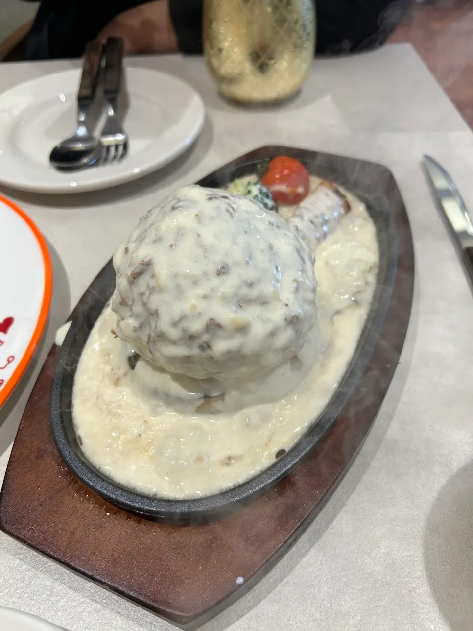 Sizzling cheese katsu covered in poured white cheese
