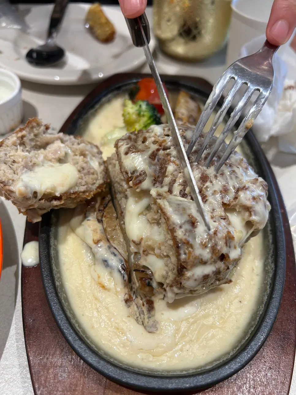 Cross-section of the sizzling cheese katsu showing cheese inside