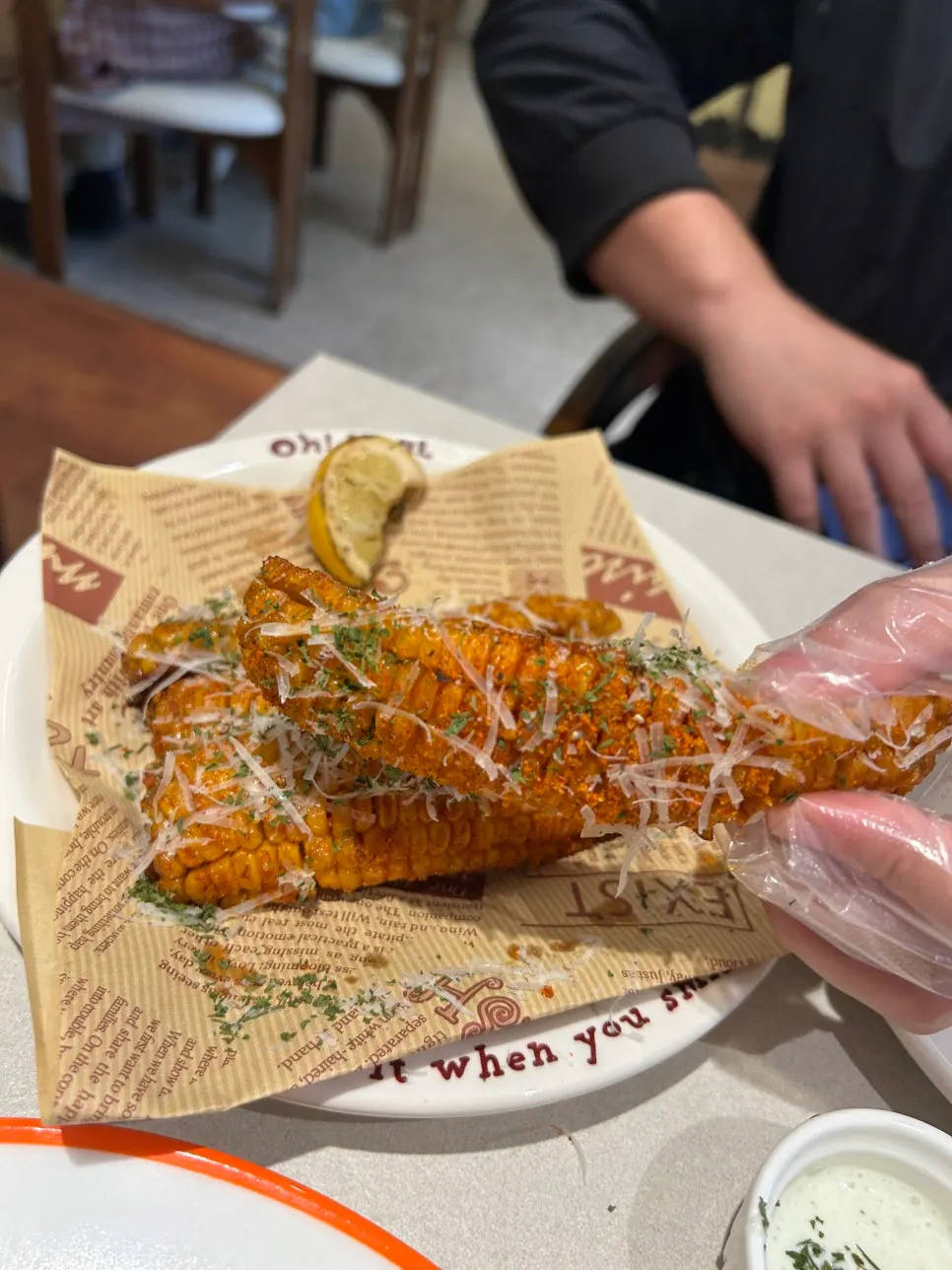 Long-cut corn fritters held with a plastic glove
