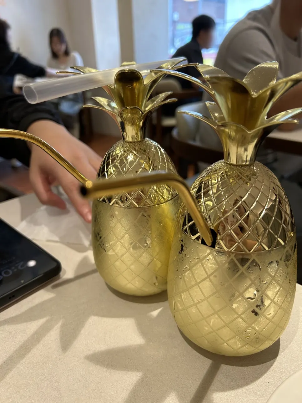 Pineapple ade served in a gold pineapple-shaped cup